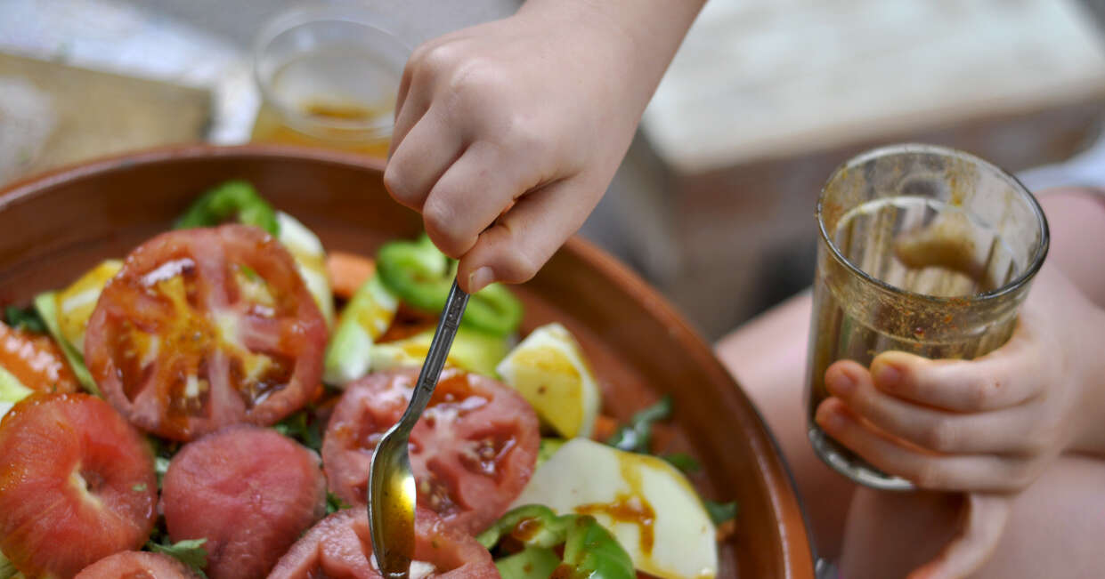 Child making Moroccan salad